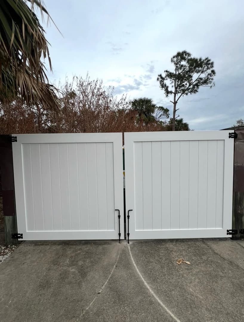 White vinyl double gate installation on driveway in North Port FL