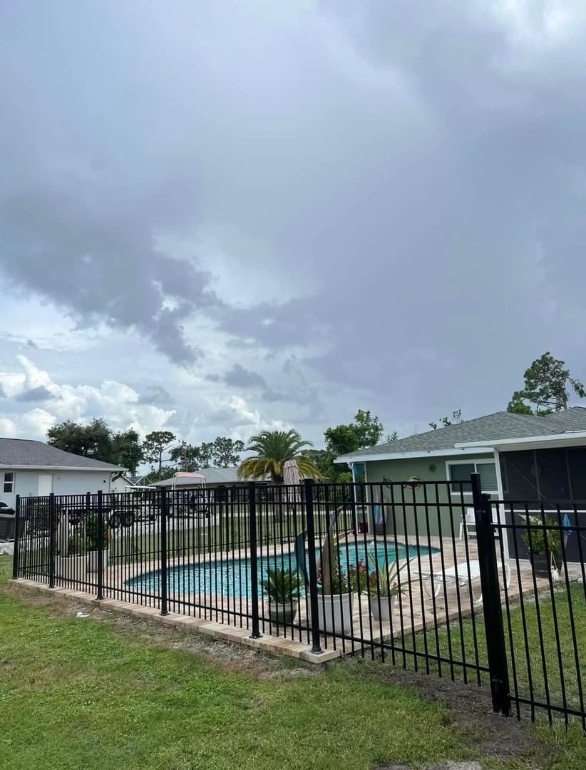 Black aluminum pool safety fence installation in Port Charlotte FL