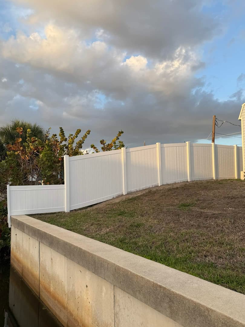 Long white vinyl privacy fence along property line in North Port FL